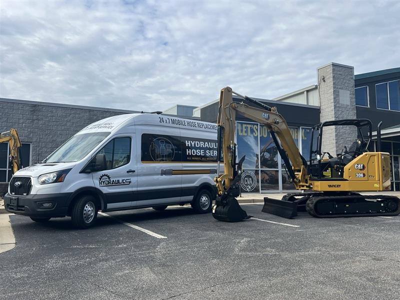 On-Site Hydraulics Van in a Parking Lot with a Caterpillar 306 Mini Excavator